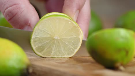 men hands cut lime into round slices.