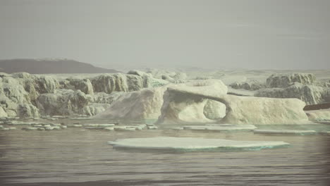 blue icebergs of antarctica with frozen and snow covered antarctic scenery