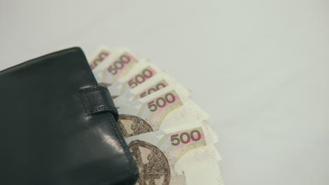 500 polish zloty under black wallet