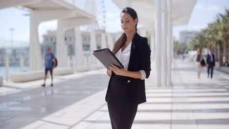 Elegant-businesswoman-on-a-seafront-promenade