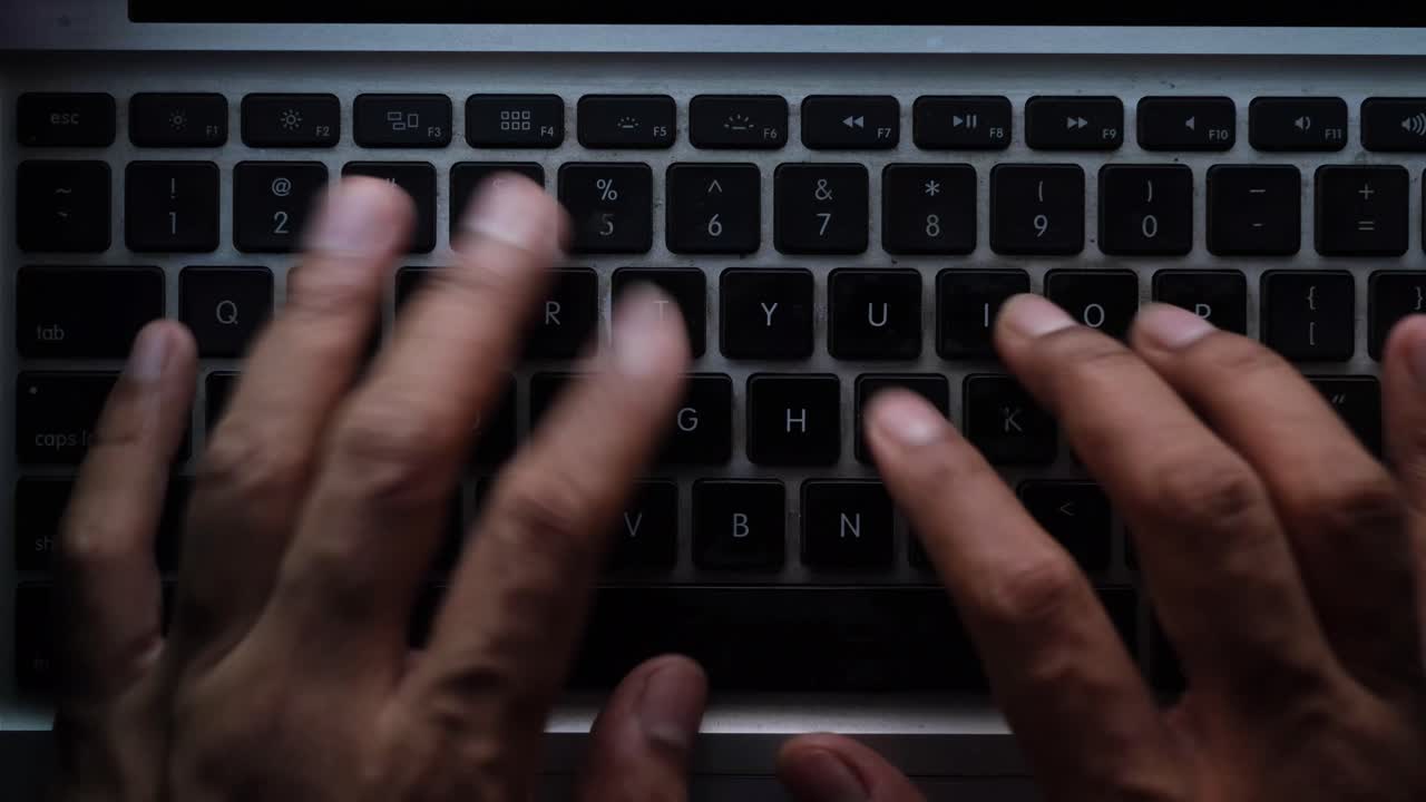 Hands Typing on a Laptop Keyboard