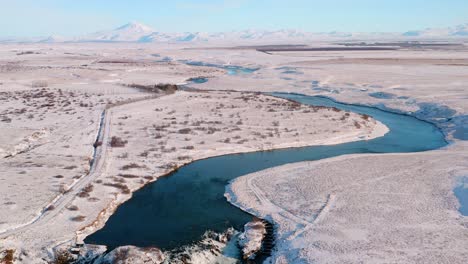 Beautiful-snowy-winter-landscape-with-Arbaearfoss-waterfall-at-sunny-day