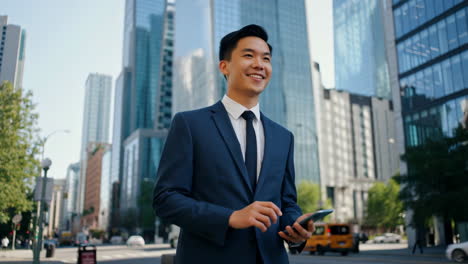 young asian businessman using smartphone in modern city