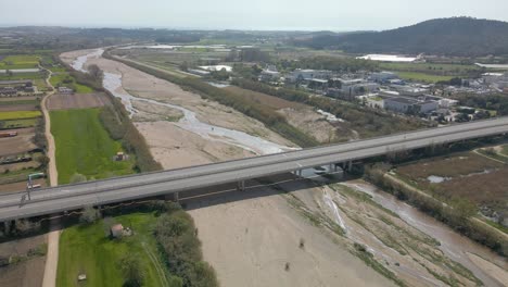 Aerial-circling-shot-of-Spanish-highway-over-Tordera-River