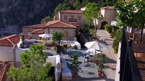 Stone-terraces-of-beautiful-village-in-Albania,-built-on-rocky-mountain-over-Ionian-seaside,-paradise-quiet-resort,-idyllic-for-summer-vacation