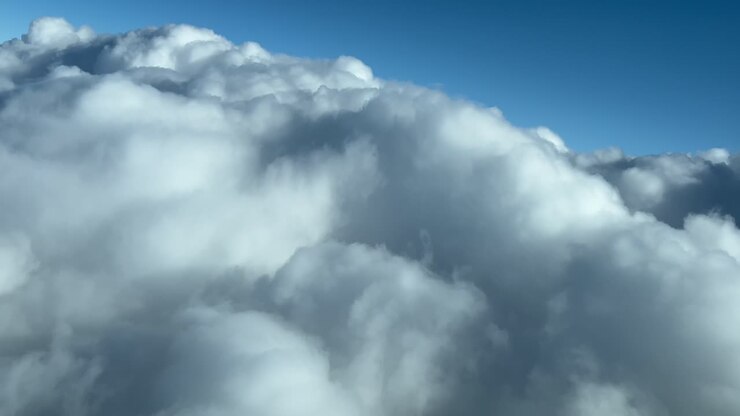 Clouds scene shot in a real time flight as seen by the pilots while flying across a sky full of stormy clouds