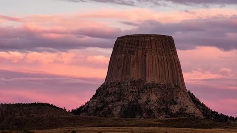 devils tower national monument at sunset with pink and purple sky