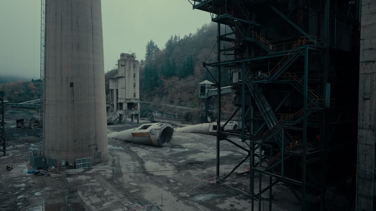 Abandoned Industrial Factory Site with Tall Chimney and Decaying Structures