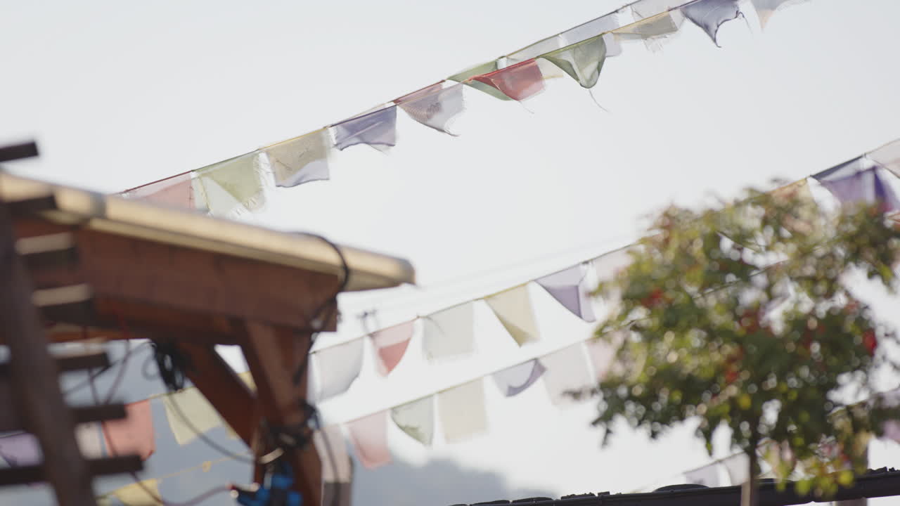 Tibetan prayer flags fly in the breeze above Salt arts and music venue
