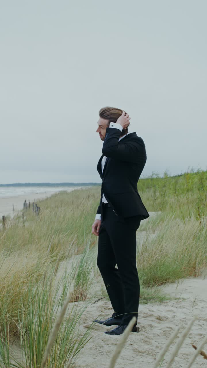 Man in a suit on a beach