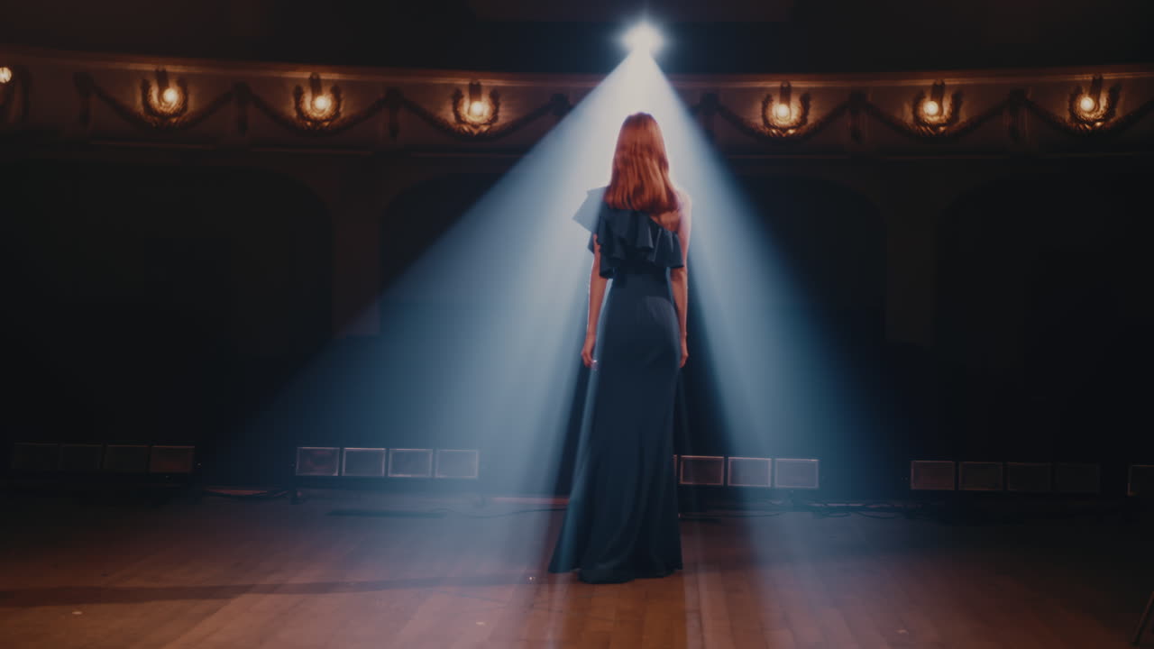 Anonymous Actress Walking on Stage back View of Unrecognizable Woman in Elegant Dress Walking on Stage Past Curtains then Starting to Talk and Gesticulate in Spotlight during Performance on Stage