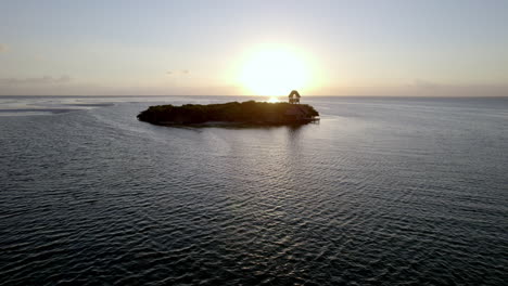 Drone-view-of-small-island-on-the-beach-with-blue-sky-and-drifting-white-clouds