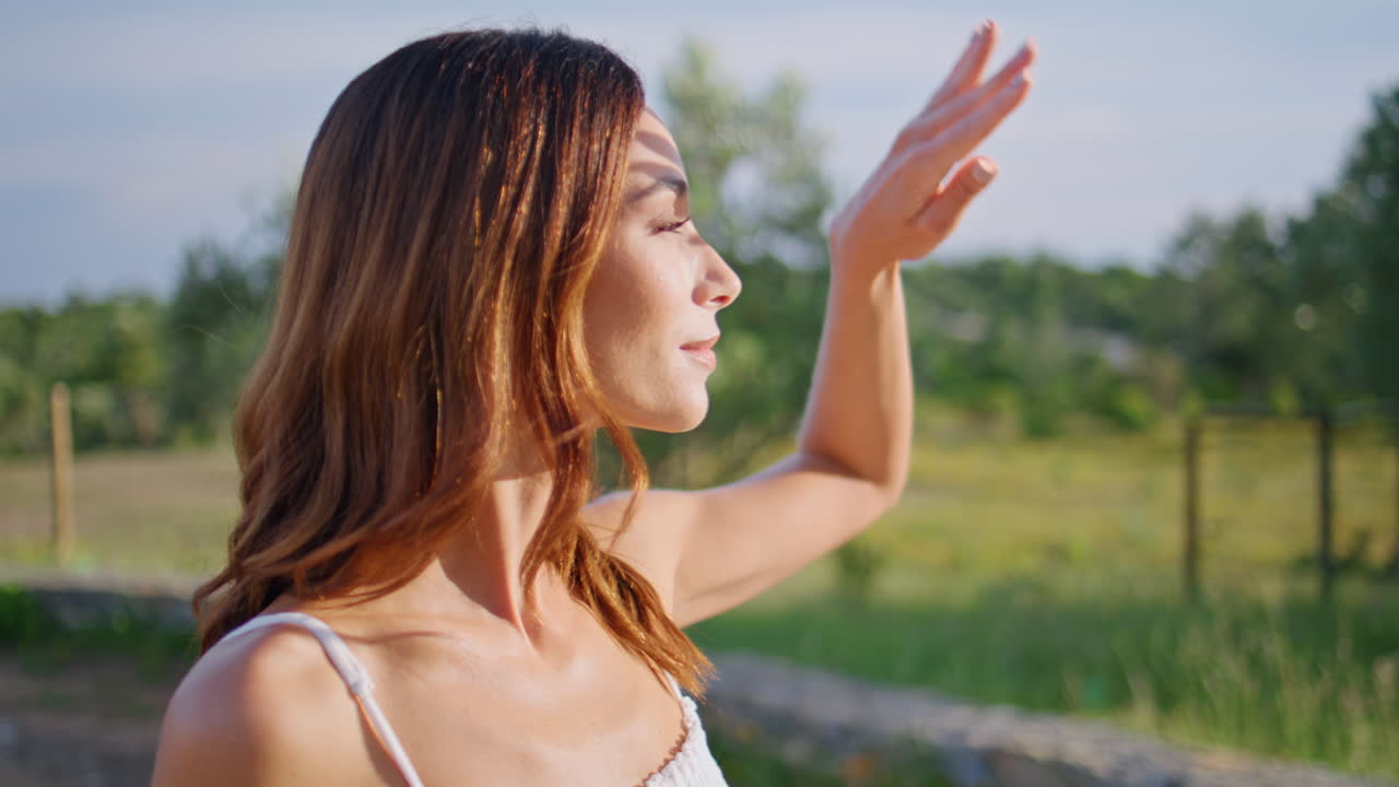 Romantic woman warming sunlight resting rural nature closeup. Country model