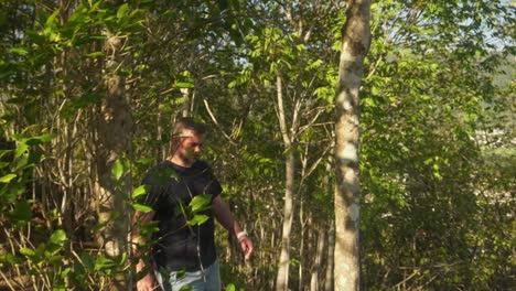 man walking downhill along a nature walk side shot.