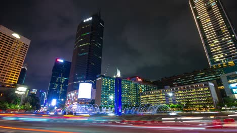 night illumination jakarta city center famous traffic street circle fountain timelapse panorama 4k indonesia