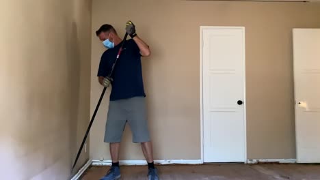 man wearing a mask and demoing a wall - static, slow motion shot