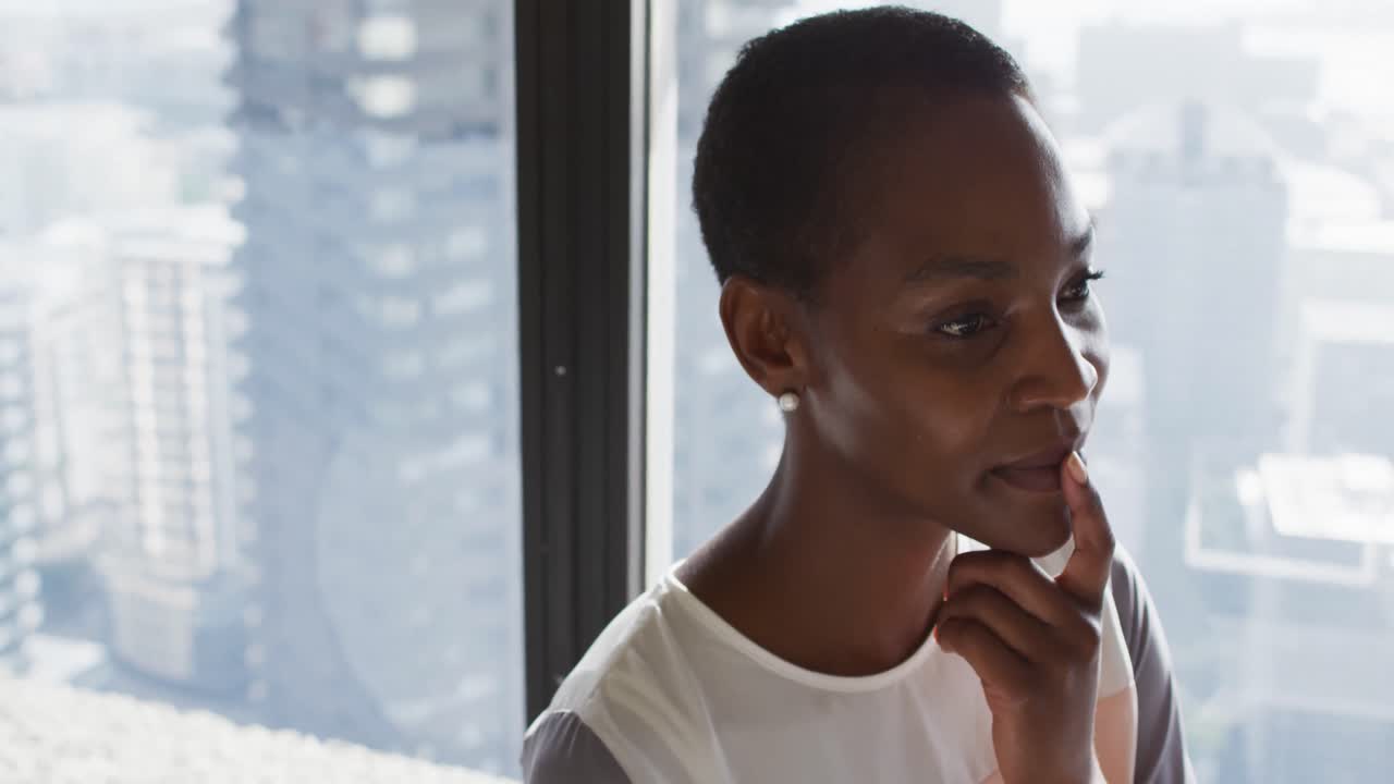 Portrait of african american businesswoman thinking at window