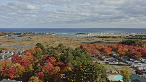 Wells-Maine-Aerial-v8-panoramic-pan-around-the-small-countryside-town-overlooking-at-beautiful-salt-marsh-estuary-and-harbor-surrounded-by-colorful-autumn-tress-during-fall-season---October-2020