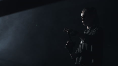 young woman preparing for training in a dramatic, smoky environment