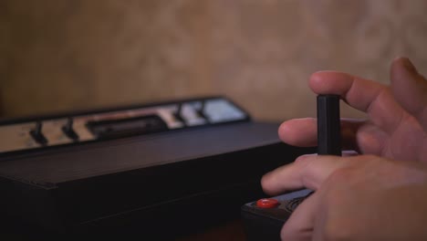 playing with vintage tv video game console joystick. 4k footage