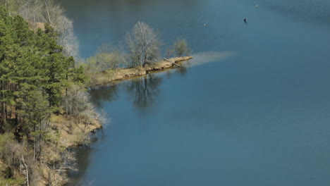 calm waters with motor boat in glen springs lake in tipton county, tennessee, usa