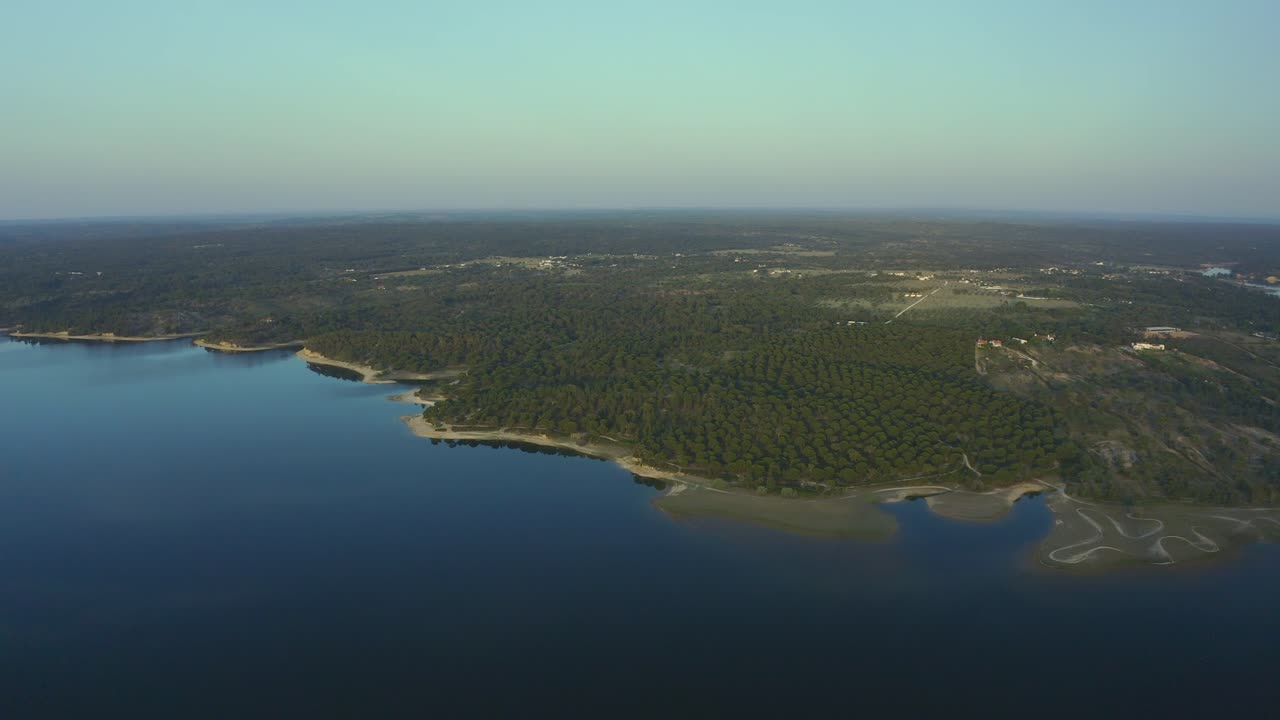 Aerial view of lake close to the green area at huge sunset, Portugal. Alentejo.