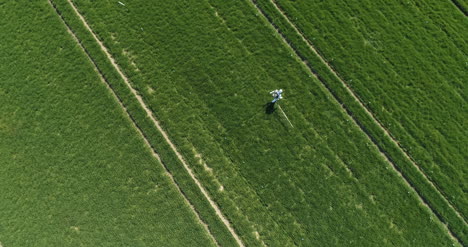 agricultural researcher spraying filed with herbicides or pesticides