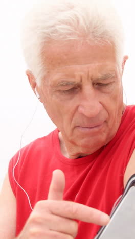 retired man listening to music on the beach