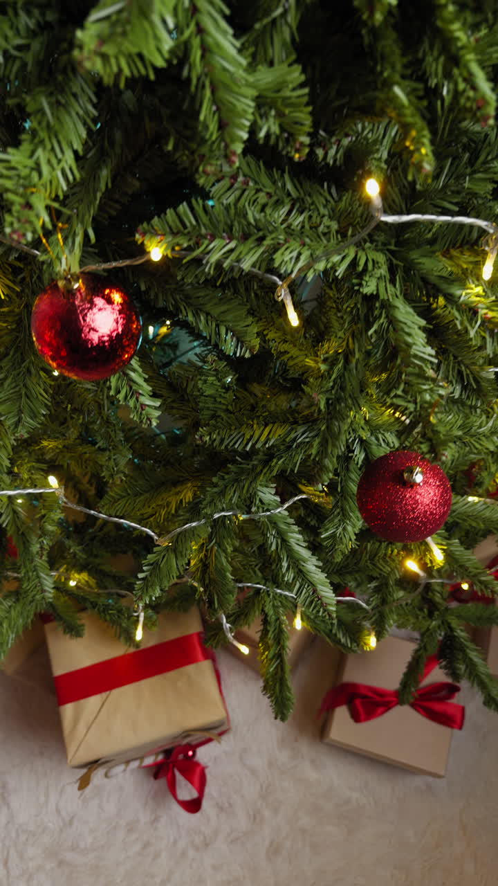 Red Balls on a Christmas Tree at Night with Lights