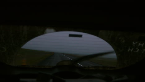 looking out rear view window driving through storm in iceland