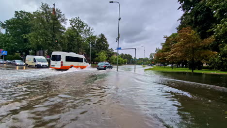 cars drive through flooded streets in europe after heavy rains caused by climate change