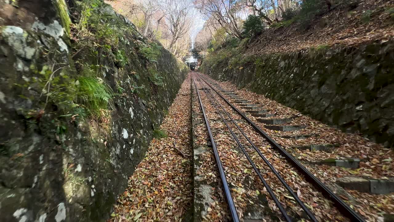 Cable car going down mountain during autumn season, POV shot
