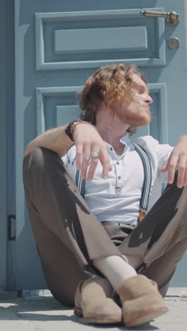 stylish man sitting outdoors