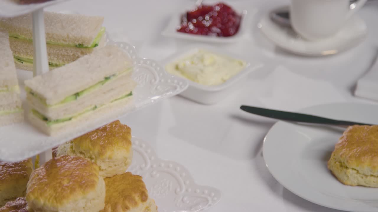 Studio Shot Of Traditional British Afternoon Tea With Sandwiches Cake Scones Cream And Jam 2
