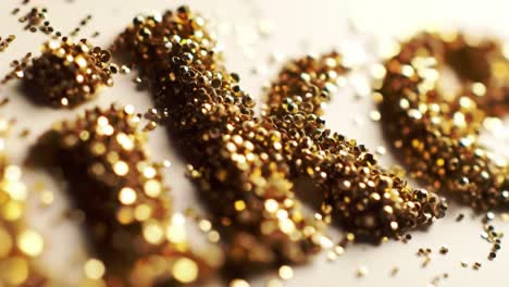 artists are crafting exquisite decorations using shimmering golden glitter. the careful arrangement and attention to detail enhance the festive atmosphere.
