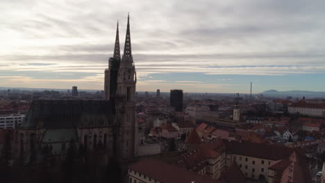 Zagreb-Cathedral-Aerial-Rise-Up-Shot-At-Sunset,-Croatia