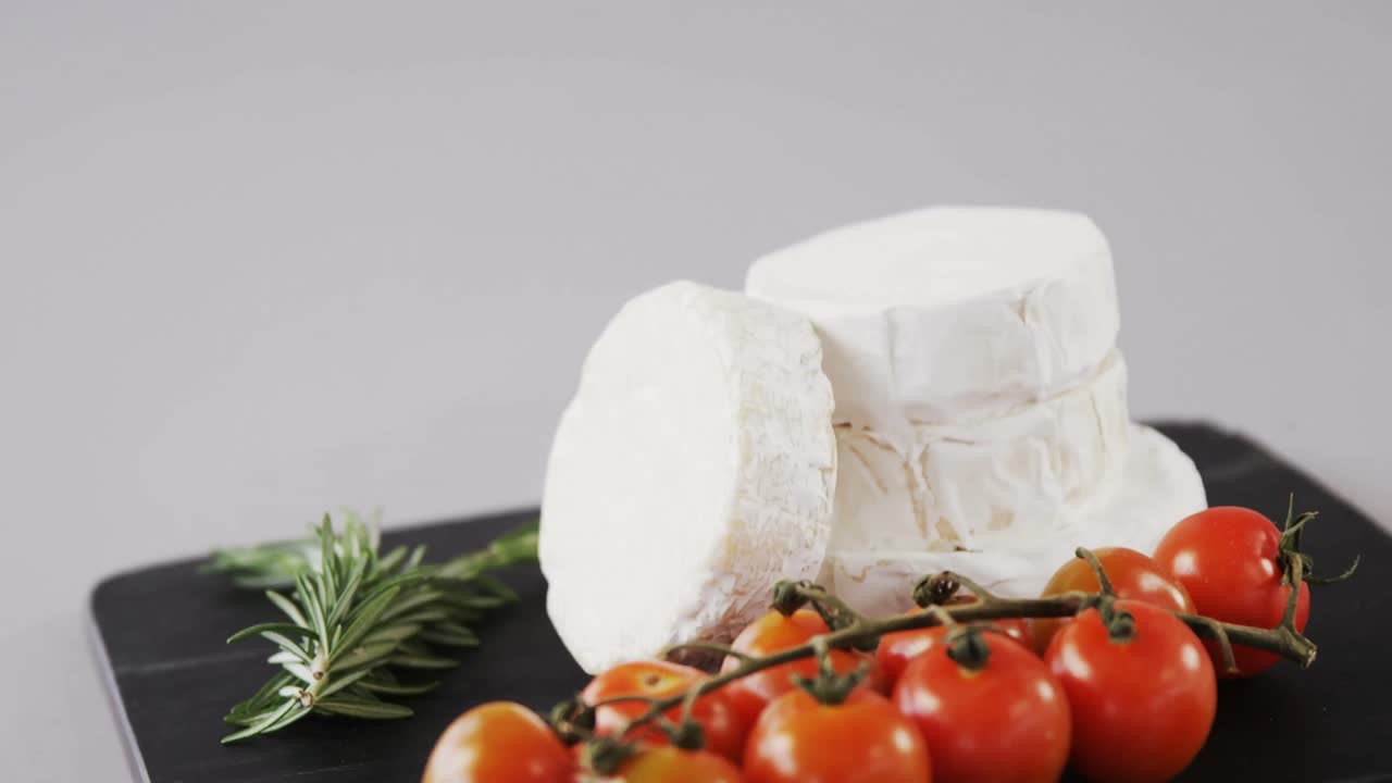 Cheese with tomatoes and rosemary herb