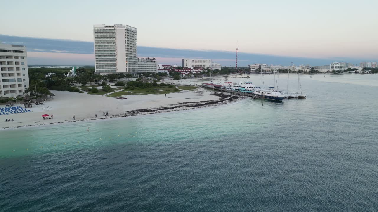 Playa langosta in cancun with turquoise waters and beachfront resorts, aerial view