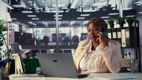 businesswoman working on laptop and phone call