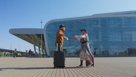 elderly old husband wife retirees tourists reunion meeting in airport terminal after long separation