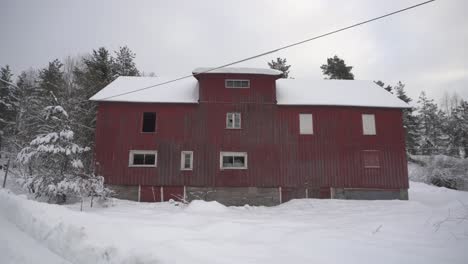 Traditional-Red-Barn-House-Amidst-Frozen-Landscape-During-Winter-In-Norway