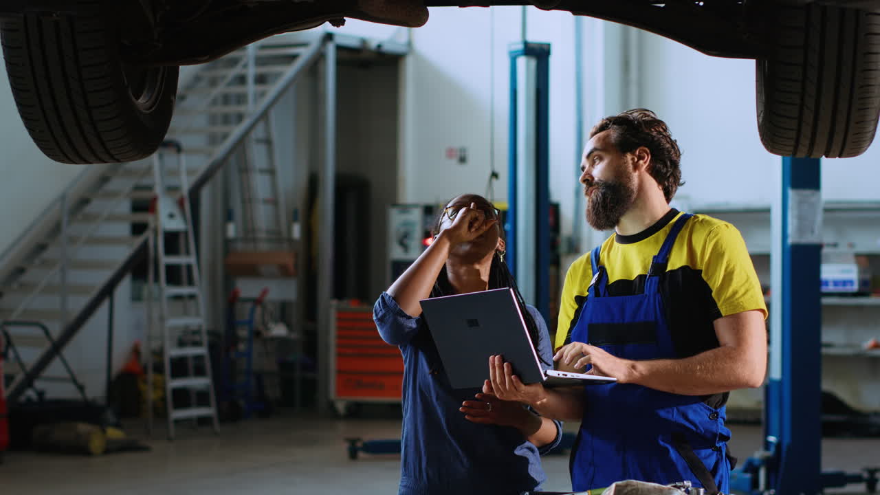 Mechanic and woman look for car parts