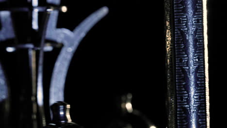 close up macro of an old clock pendulum clockwork gear with a turning movement
