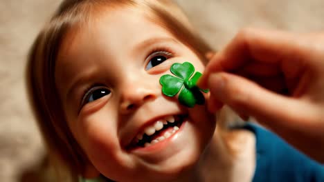 smiling baby girl with shamrock on face