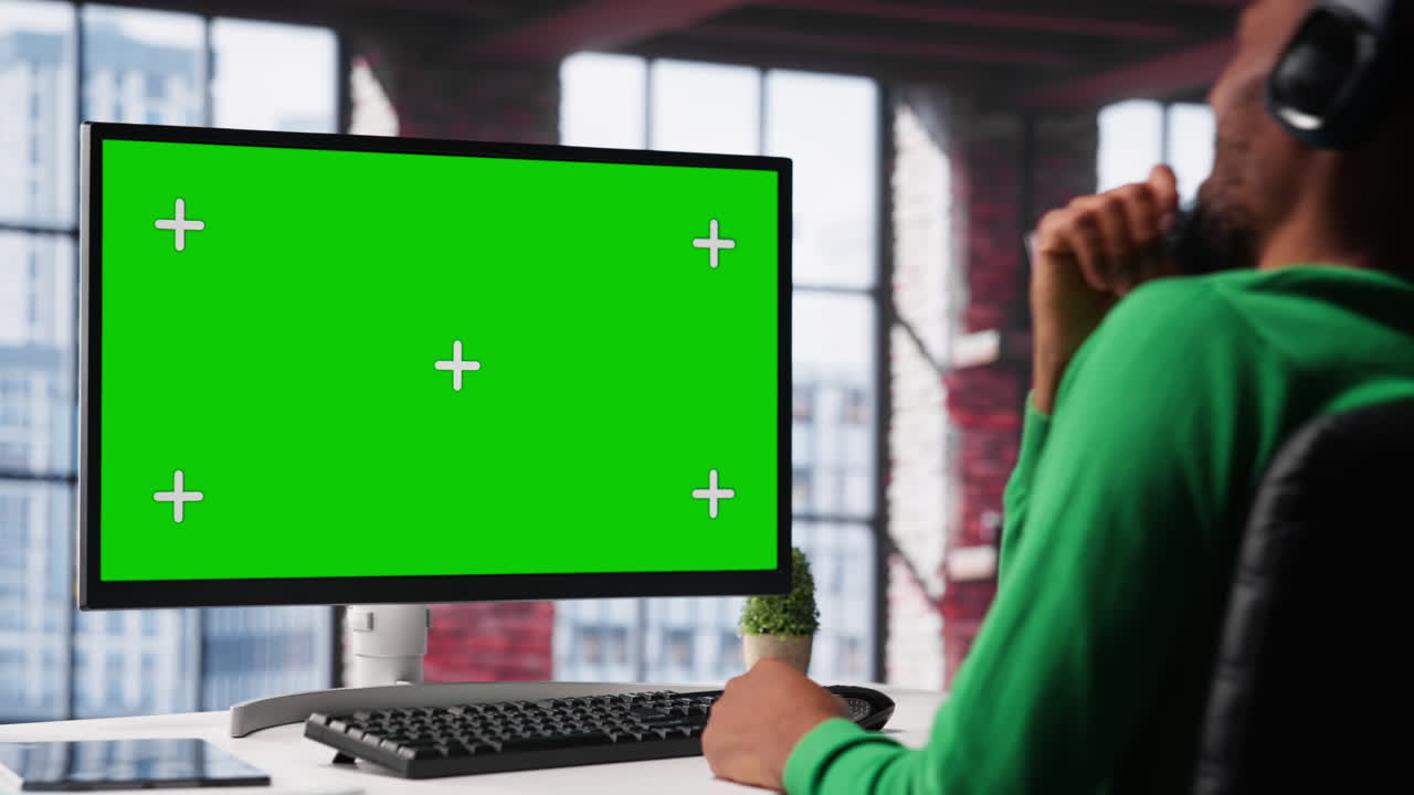 Young adult at home office analyzing data charts on mockup computer