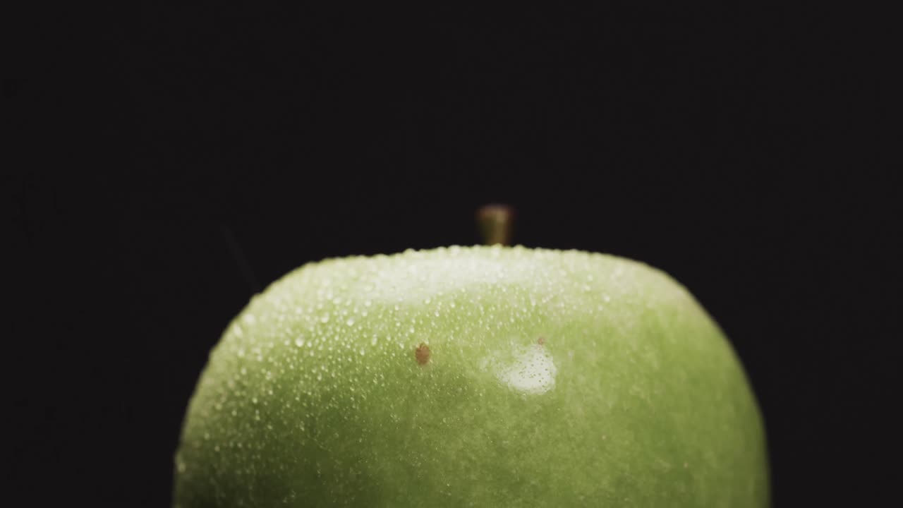 micro vídeo de primer plano de la manzana verde con espacio de copia en fondo negro