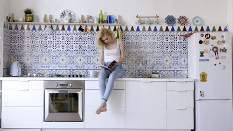 woman reading in a stylish kitchen