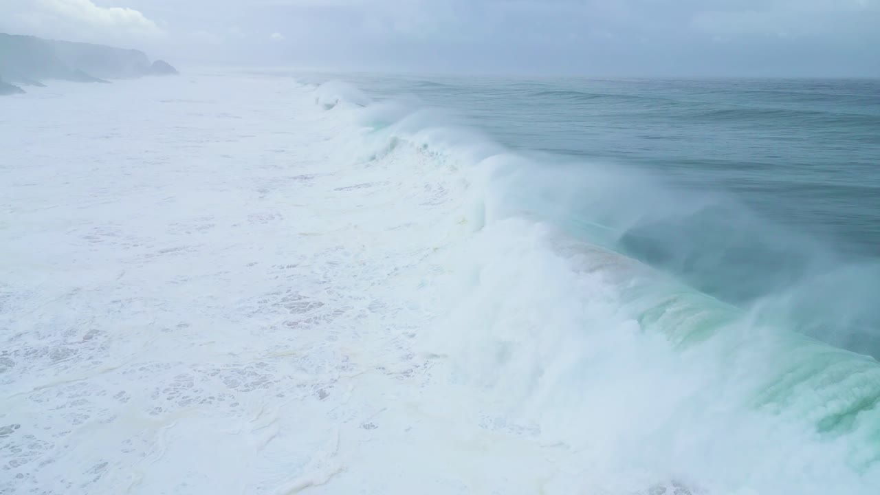 Waves crashing on a beach in Aljezur, Portugal, captured in slow motion