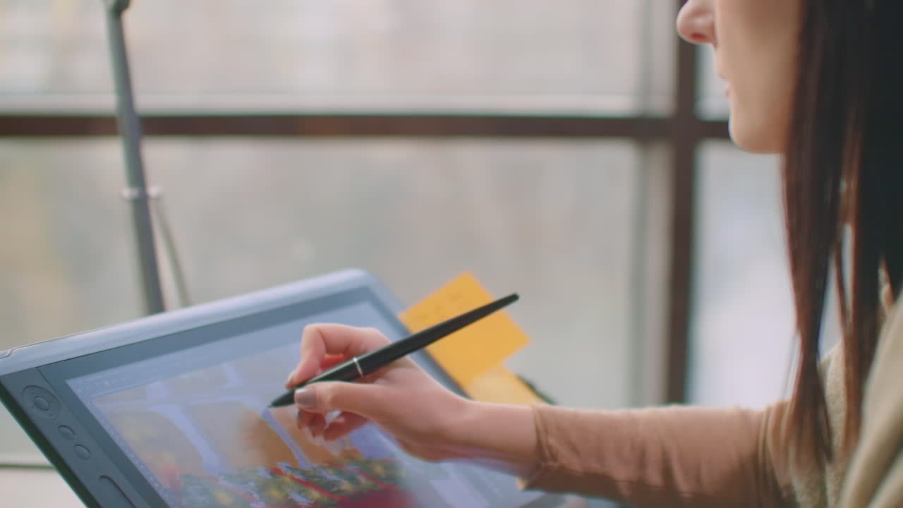 Young Woman Sitting at Her Desk She's Drawing Writing and Using Pen with Digital Tablet Computer. Hands with Pen