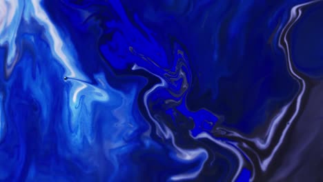 Video-of-close-up-of-blue-and-white-ink-in-water-with-copy-space